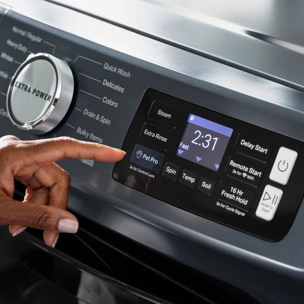 A person selecting the Pet Pro Option on a washing machine