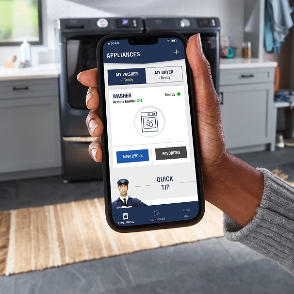 A hand holding a phone with the Maytag™ app screen