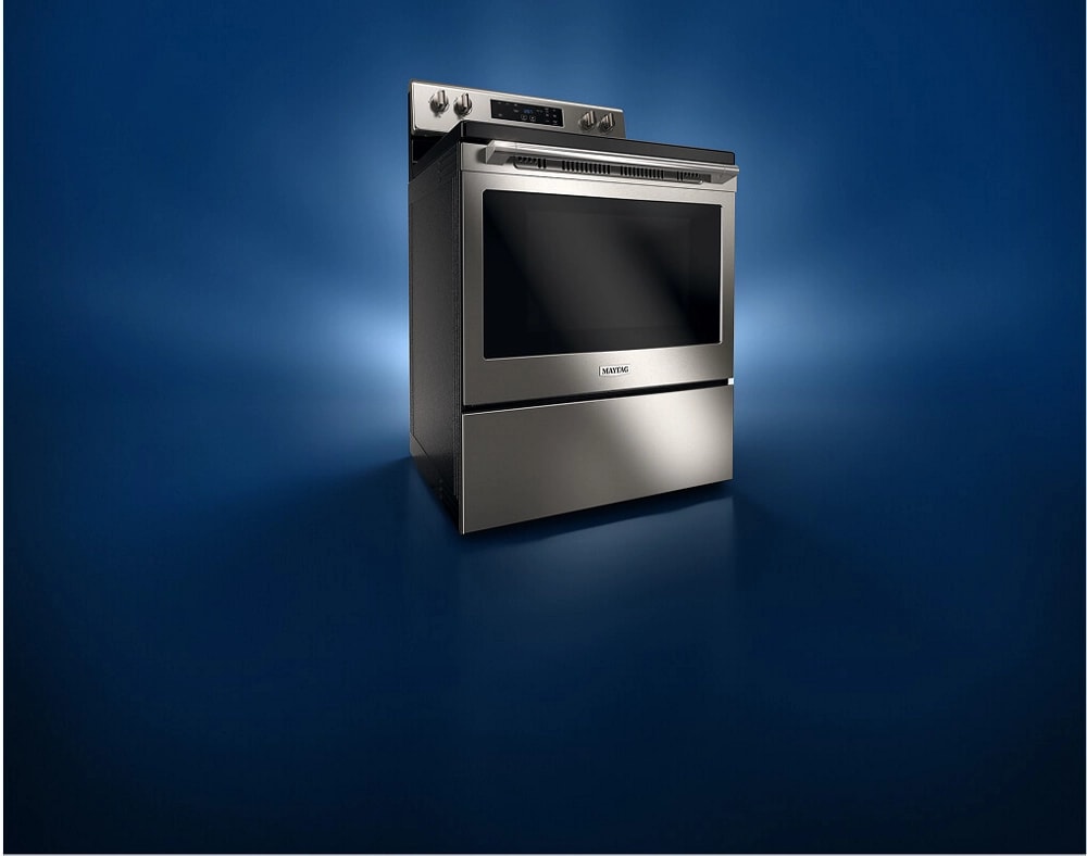 A stainless steel gas kitchen range against a black background.