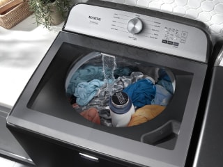 Top load washer filled with a load of laundry