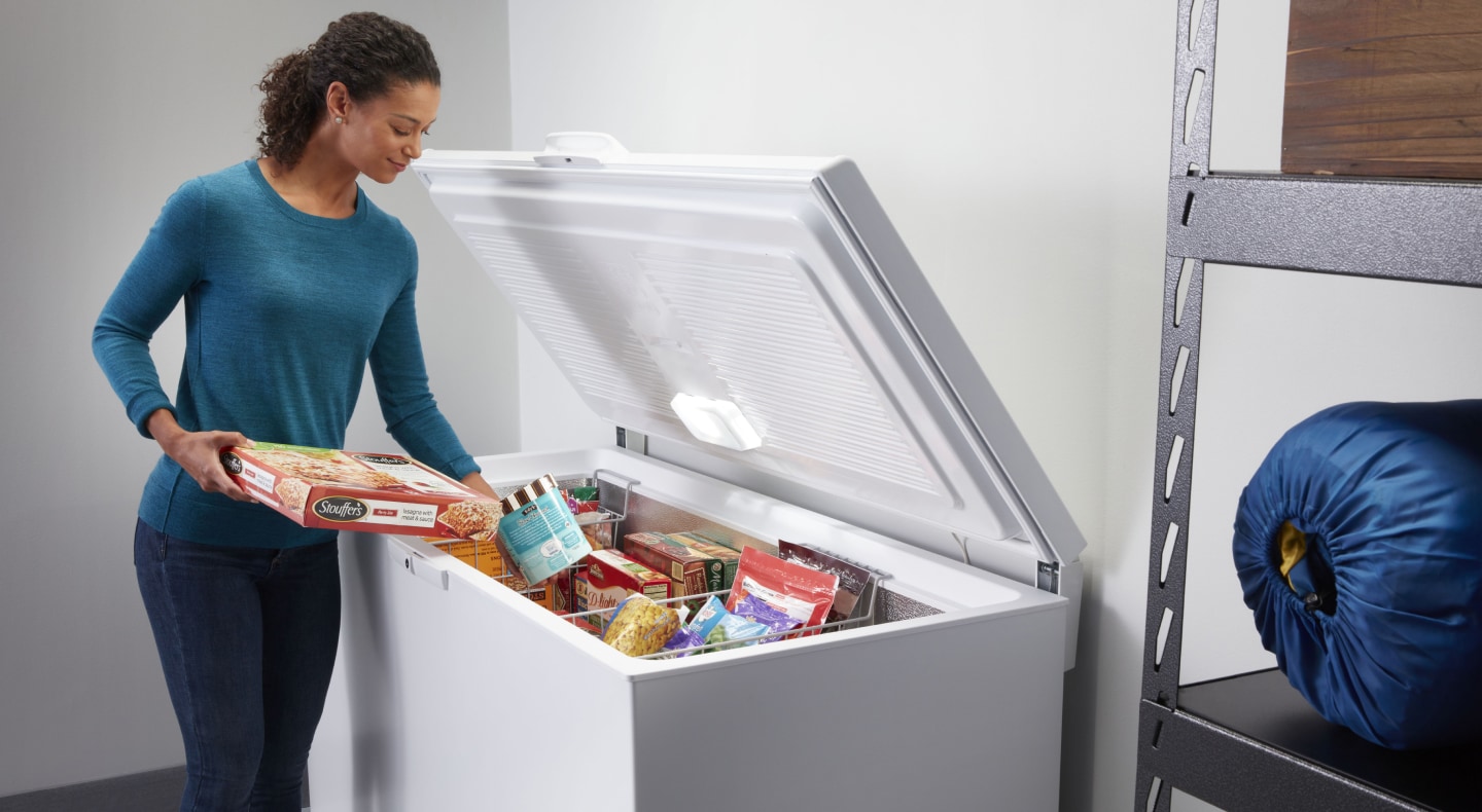 Person putting food in a freezer Person putting food in a freezer
