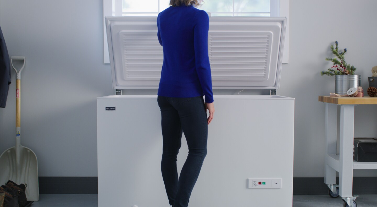 Person opening a freezer Person opening a freezer