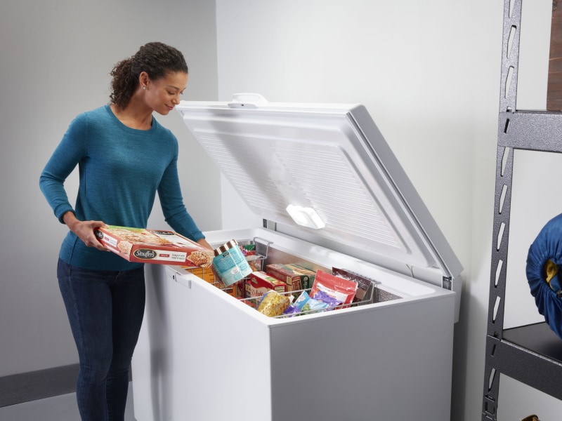 Person putting food in a freezer Person putting food in a freezer