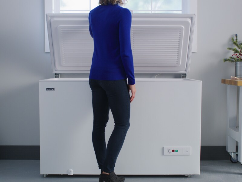 Person opening a freezer Person opening a freezer