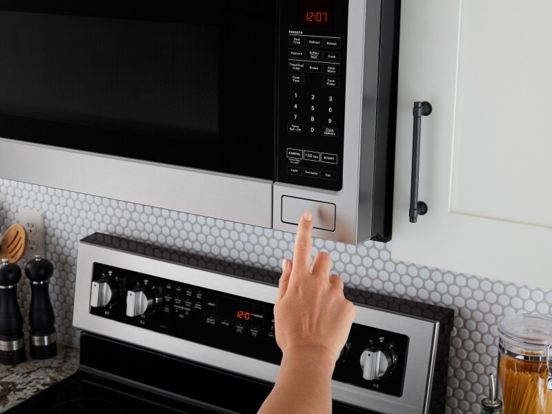 A finger making a selection on a Maytag® microwave A finger making a selection on a Maytag® microwave