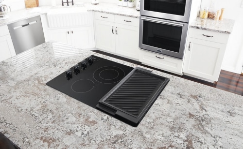 An overhead view of a Maytag® electric cooktop in a modern kitchen