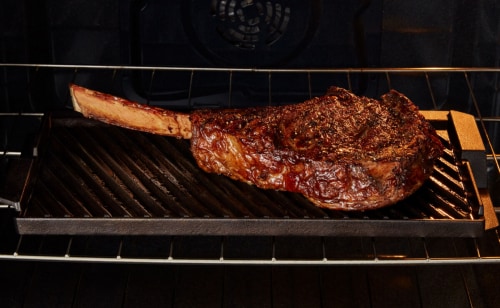 Steak grilling inside a Maytag® oven with Grill Mode