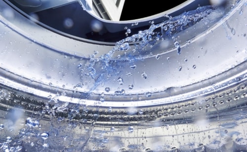 A close-up of the interior of a Maytag® washer tub with water