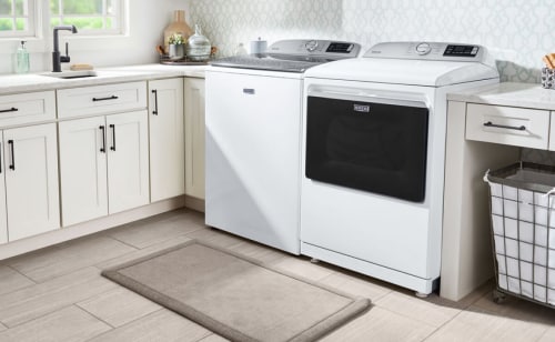 White Maytag® washer and dryer in a laundry room