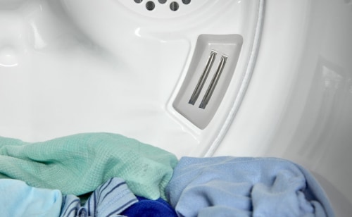 Close-up of dry clothes sitting inside a dryer drum